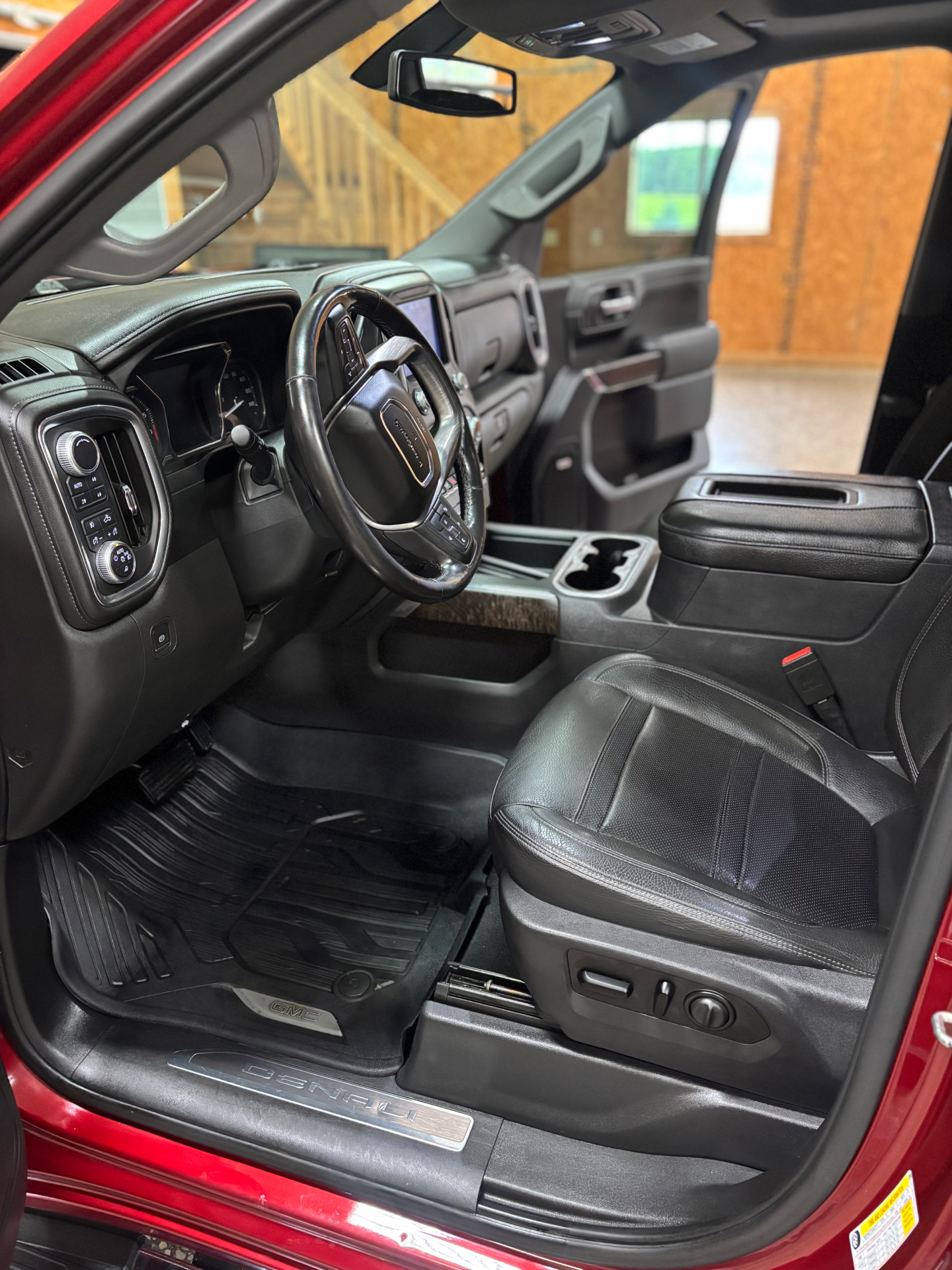 Detailed front cabin of a red GMC Denali inside Blacktop Garage