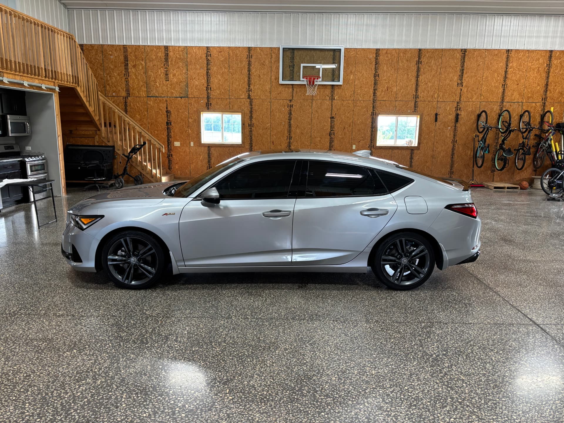 Silver Acura sedan with a mirror-like finish inside the BlackTop Garage bay