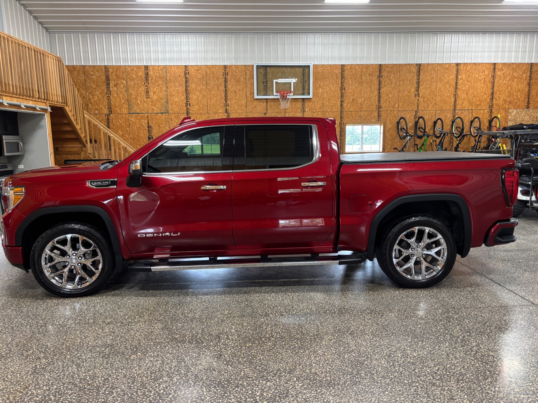 Freshly detailed red GMC Denali pickup inside Blacktop Garage