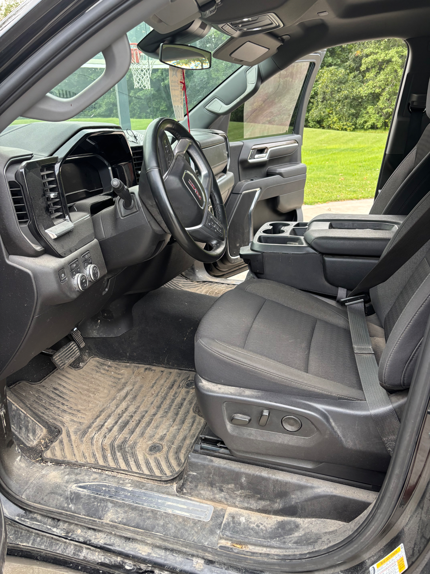 GMC interior before detailing — muddy floor mats and dusty panels