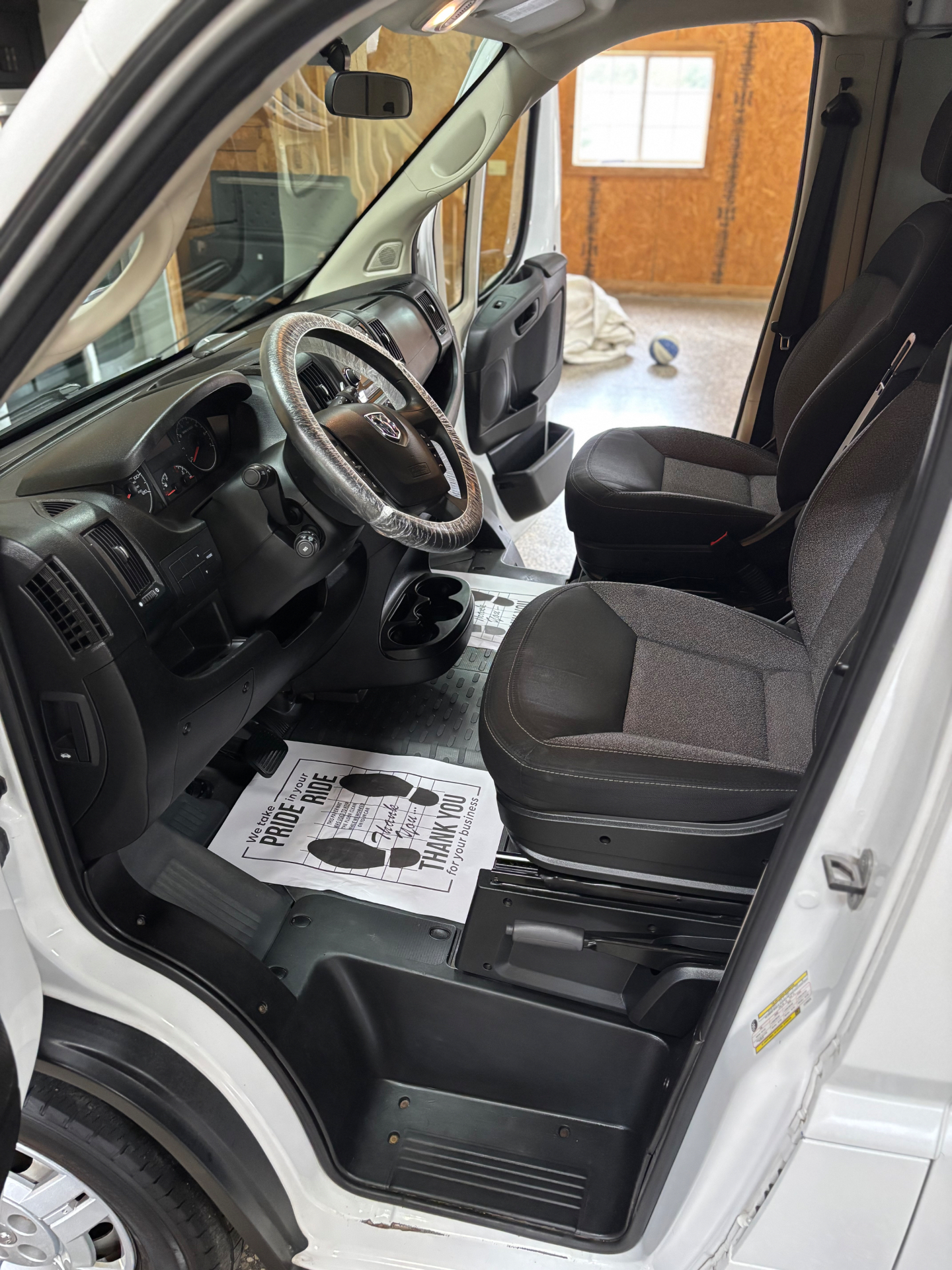 The same Ram ProMaster cab after a full interior detail — clean seats and fresh floor paper