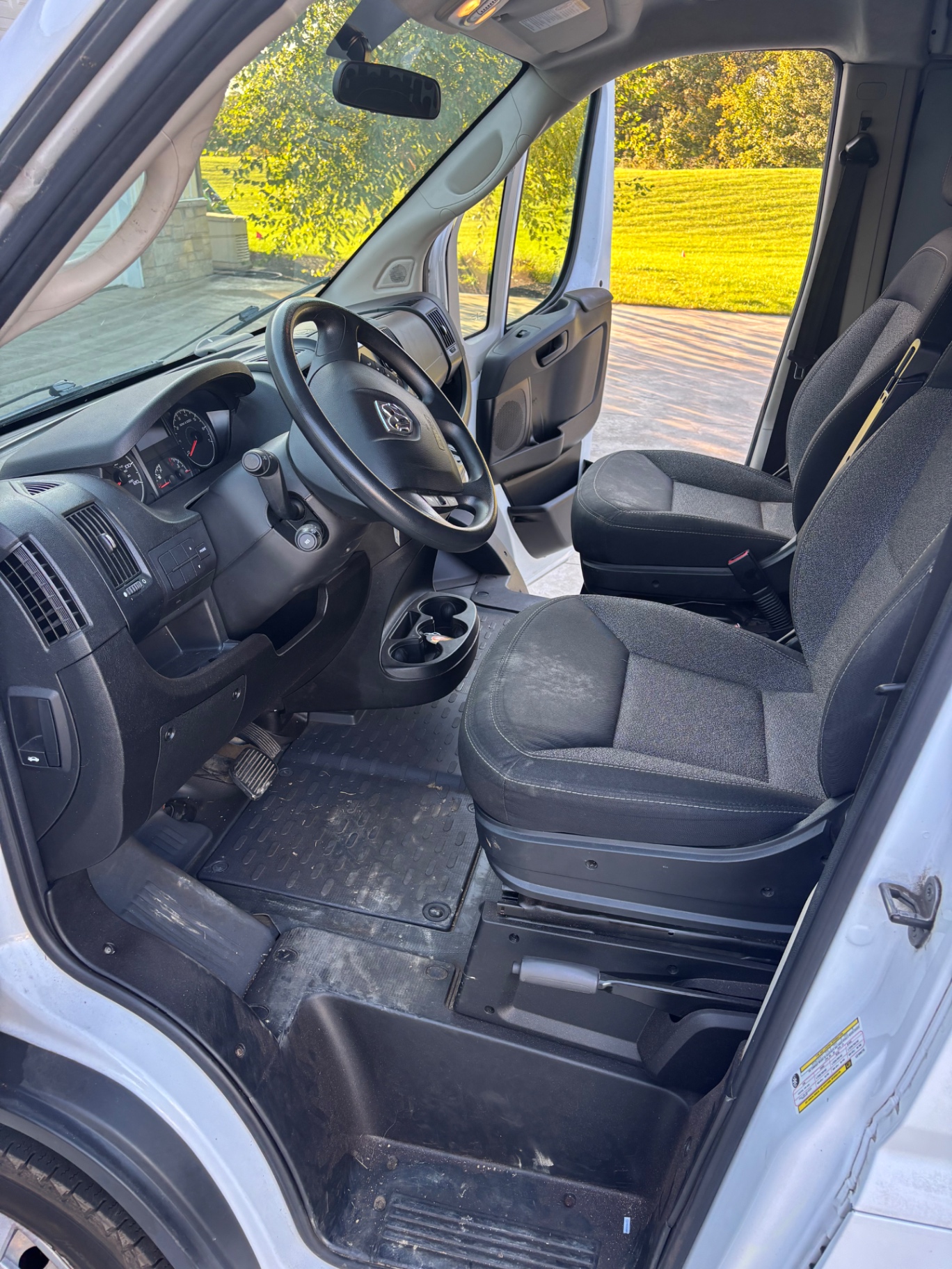 Ram ProMaster cab before detailing — dusty seats and mud on the rubber floor